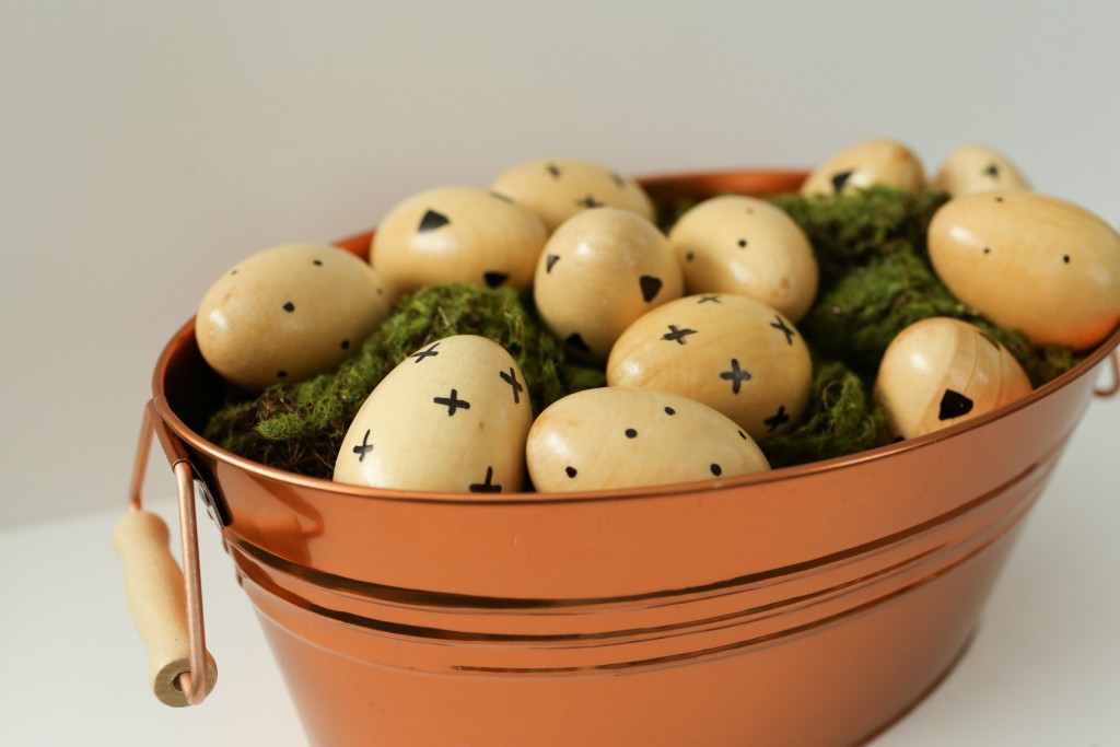 A modern take on Easter egg decorating using faux wooden eggs and a sharpie!  www.homestead128.com