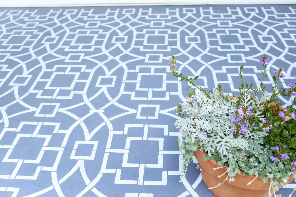 Painted cement floor using a stencil to create a cement tile look.