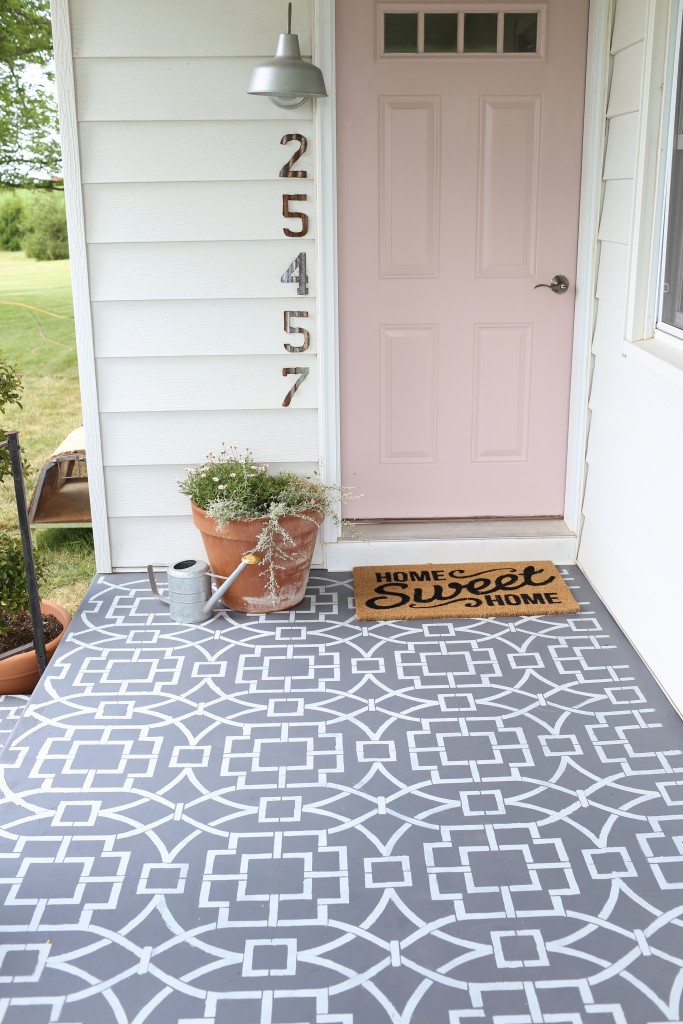Painted cement floor using a stencil to create a cement tile look.