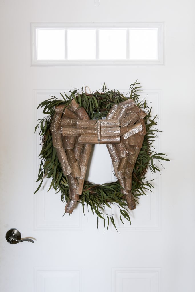 The eucalyptus willow wreath is dressed up with wooden wings for Christmas at the farmhouse.