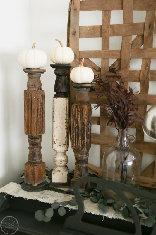 Rustic table legs for candlesticks and white pumpkins.