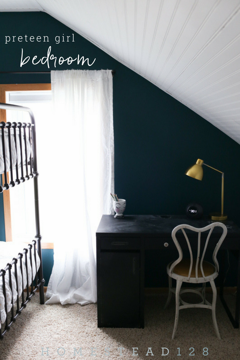 Preteen girl bedroom with dark moody walls and light white beadboard.