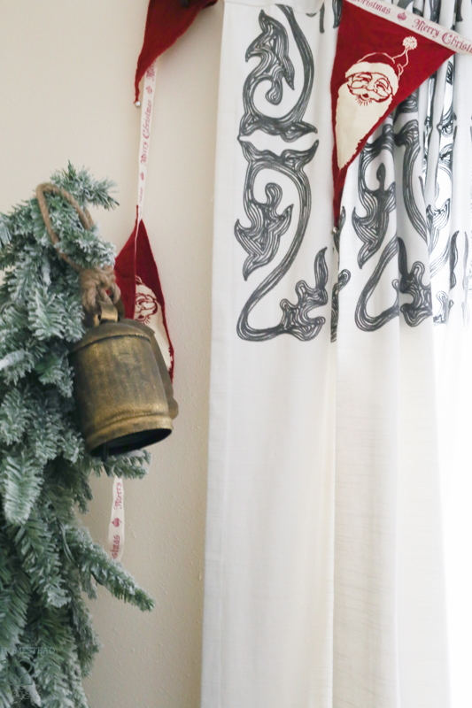 Miniature flocked trees and red Santa bunting fill the corners for the farmhouse at Christmas.