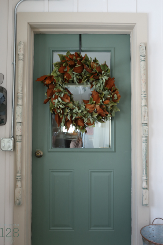Christmas at the farmhouse with a magnolia and seeded eucalyptus wreath.