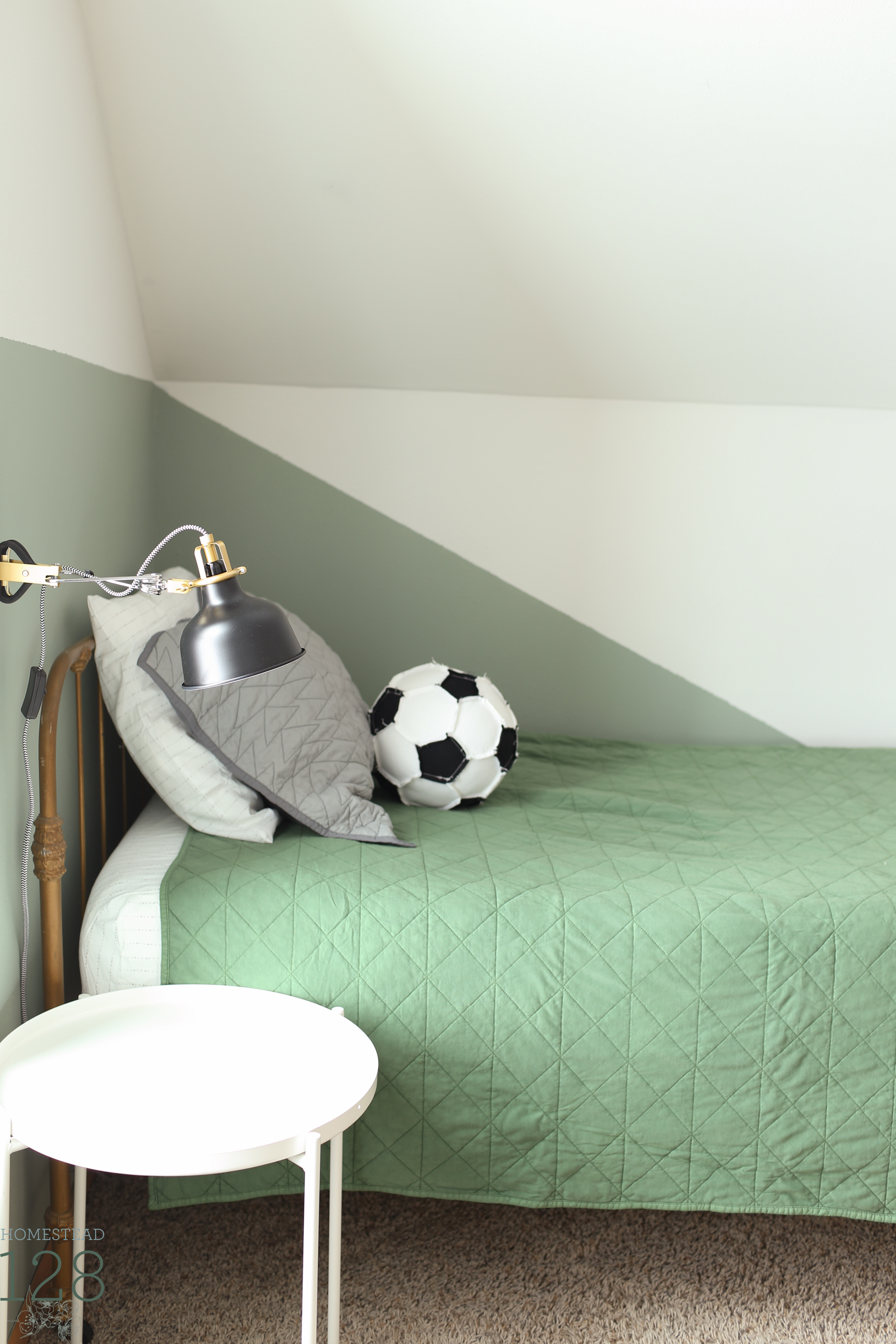 The boys vintage industrial shared bedroom brings in green, gray and white for a color scheme they can grow into.