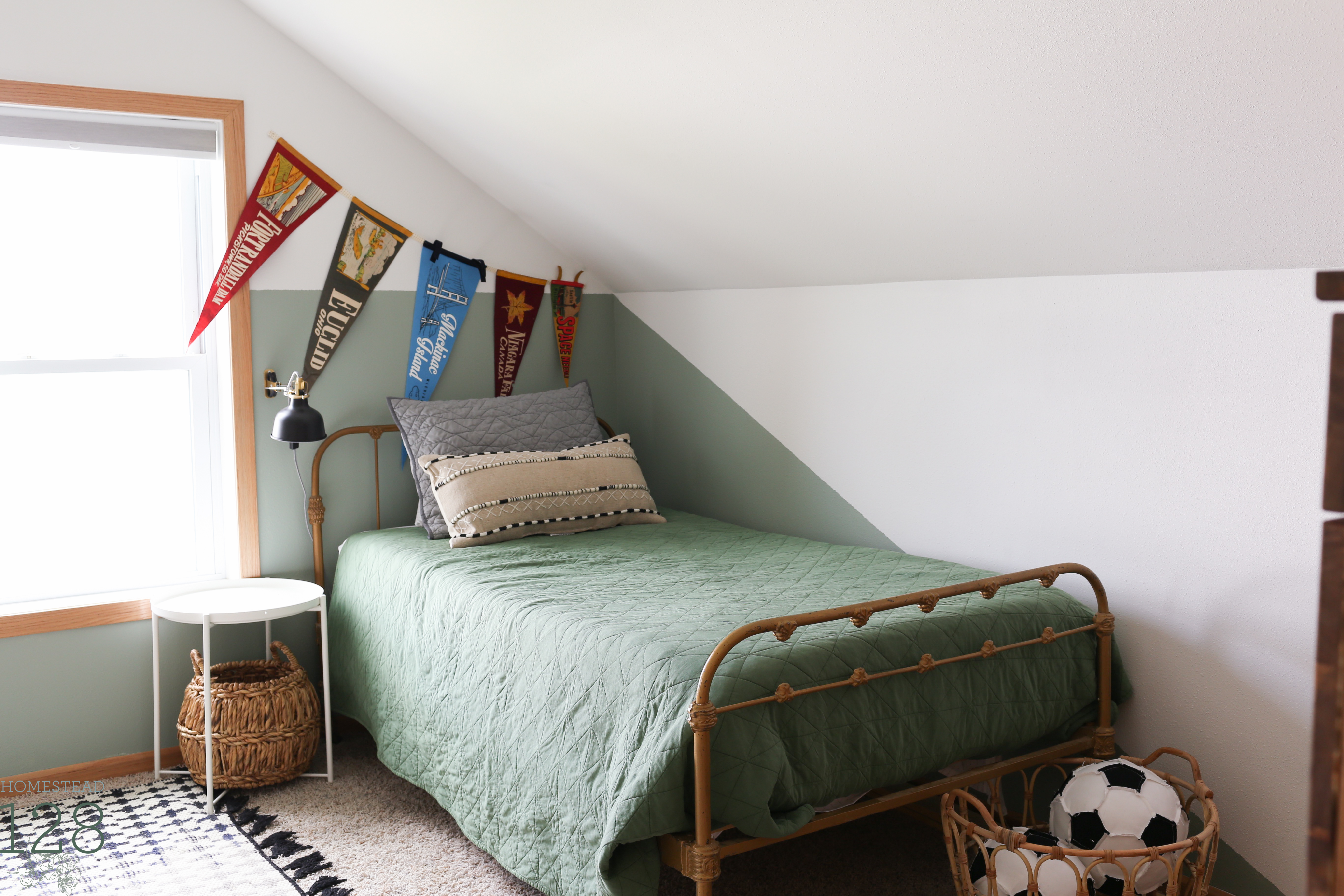 The vintage and playful boys bedroom is full of personal touches, white, black, green and gold.