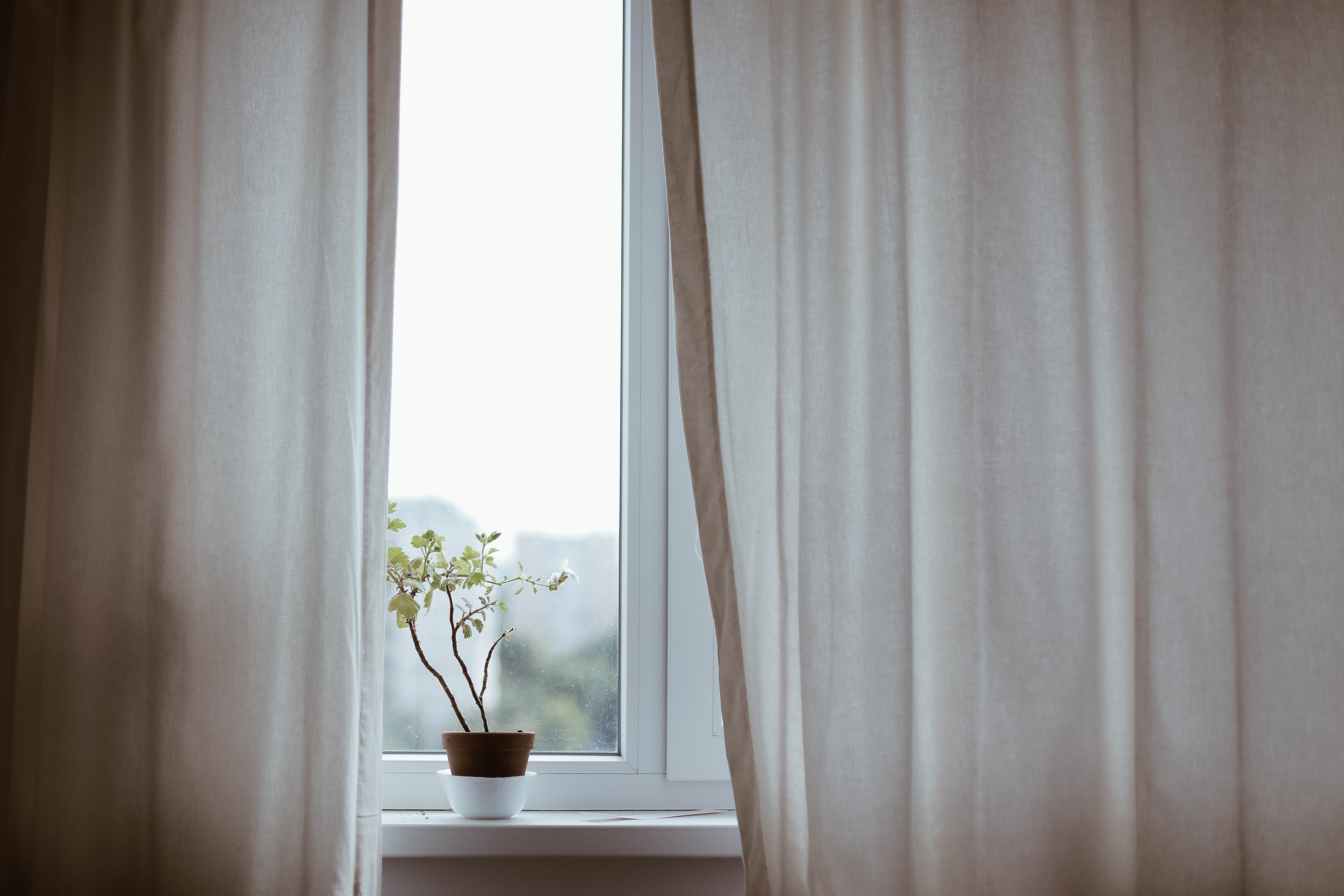 Adding curtains to your home to create a cozy space.